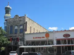 Limestone storefronts on the downtown Georgetown square with an onion dome tower on the corner