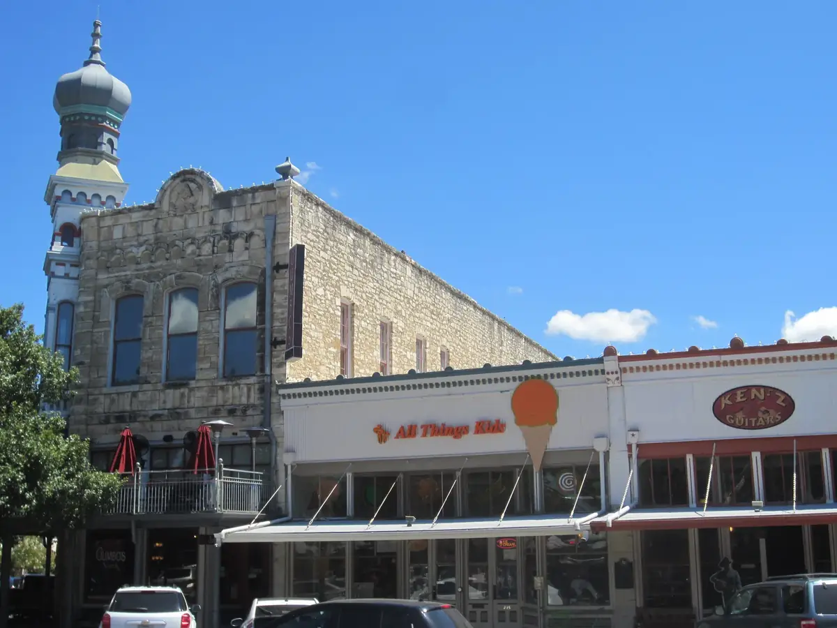 Limestone storefronts on the downtown Georgetown square with an onion dome tower on the corner